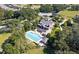 Aerial view of a community pool with sundeck, lounge chairs, and a landscaped surrounding at 30245 Cheval St, Mount Dora, FL 32757