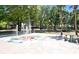 Community splash pad with a water feature, picnic tables, and park area with mature trees at 30245 Cheval St, Mount Dora, FL 32757