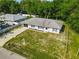 This aerial view shows the home is nestled amongst mature trees, a spacious yard, and a long driveway at 3104 Lime Tree Dr, Edgewater, FL 32141