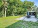 The large backyard features a stone patio and beautiful landscaping, perfect for outdoor entertaining at 3104 Lime Tree Dr, Edgewater, FL 32141
