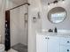 Bathroom featuring stylish vanity with a walk-in shower with a unique shower curtain at 3104 Lime Tree Dr, Edgewater, FL 32141