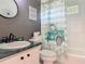Well-lit bathroom with a white vanity, a toilet, and a tub/shower combo at 3104 Lime Tree Dr, Edgewater, FL 32141