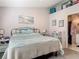 Cozy bedroom with a comfortable bed and soothing beach themed accents at 3104 Lime Tree Dr, Edgewater, FL 32141