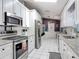 Modern kitchen featuring stainless steel appliances, white cabinets, granite countertops, and tile flooring at 3104 Lime Tree Dr, Edgewater, FL 32141