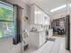 Well-lit kitchen with white cabinets, granite countertops, tile backsplash, and view to the backyard at 3104 Lime Tree Dr, Edgewater, FL 32141