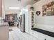 Spacious kitchen with white cabinetry, stainless steel appliances, granite countertops, and adjacent dining nook at 3104 Lime Tree Dr, Edgewater, FL 32141