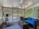 The screened in lanai features comfortable seating, exercise equipment, and plenty of natural light at 3104 Lime Tree Dr, Edgewater, FL 32141
