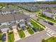 Overhead shot showcasing neat townhomes with driveways and green lawns in a Primary-planned community with crosswalks at 3206 Water Sprite St, Orlando, FL 32808