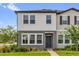 Charming two-story home featuring a well-manicured lawn and modern architectural details at 3206 Water Sprite St, Orlando, FL 32808