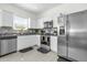 Modern kitchen featuring stainless steel appliances, granite countertops, and stylish backsplash at 3206 Water Sprite St, Orlando, FL 32808