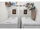 Well-organized laundry room with washer, dryer, shelving, and charming decor at 3206 Water Sprite St, Orlando, FL 32808