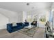 Sunlit living room with comfortable blue sofa, stylish decor, and large windows at 3206 Water Sprite St, Orlando, FL 32808