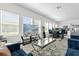 Open-concept living area with modern furnishings, large windows, and a view of the kitchen at 3206 Water Sprite St, Orlando, FL 32808