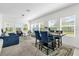 Bright open-concept living space with modern furniture, and a dining area adjacent to a kitchen at 3206 Water Sprite St, Orlando, FL 32808