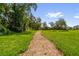 Landscaped park path with mature trees, offering a peaceful retreat for residents at 3206 Water Sprite St, Orlando, FL 32808