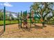 Community playground with climbing structure, slide, and wood chip ground covering for playing outdoors at 3206 Water Sprite St, Orlando, FL 32808