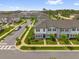 Street view of newly constructed townhomes, showcasing landscaped front yards and sidewalks at 3206 Water Sprite St, Orlando, FL 32808