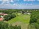 Beautiful aerial view of the neighborhood with a park, pond, and lush green landscaping on a sunny day at 3213 Kentshire Blvd, Ocoee, FL 34761