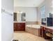 Bright bathroom with dual vanity, soaking tub, and tile flooring at 3213 Kentshire Blvd, Ocoee, FL 34761