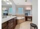 Bright bathroom with dual vanity, soaking tub, and a makeup vanity at 3213 Kentshire Blvd, Ocoee, FL 34761
