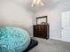 Neutral bedroom featuring a comfy beanbag chair and dark wood dresser at 3213 Kentshire Blvd, Ocoee, FL 34761