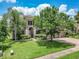Beautiful home boasts lush green lawn, mature trees, and a paver driveway at 3213 Kentshire Blvd, Ocoee, FL 34761