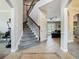 Spacious foyer with staircase, tile flooring, and views of the living room at 3213 Kentshire Blvd, Ocoee, FL 34761
