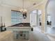 Stylish game room showcases a modern pool table and elegant chandelier lighting at 3213 Kentshire Blvd, Ocoee, FL 34761