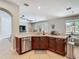 Open concept kitchen with stainless steel appliances and breakfast bar at 3213 Kentshire Blvd, Ocoee, FL 34761