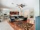 Cozy living room with hardwood floors, ceiling fan, open layout to the kitchen and game room at 3213 Kentshire Blvd, Ocoee, FL 34761