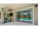 Outdoor patio featuring sliding glass doors leading to a pool area and a mounted TV for entertainment at 3213 Kentshire Blvd, Ocoee, FL 34761