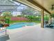 Private screened-in pool and spa surrounded by lush landscaping, creating a relaxing outdoor oasis at 3213 Kentshire Blvd, Ocoee, FL 34761