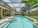 Backyard pool and spa featuring a screened-in enclosure and mature landscaping for a private retreat at 3213 Kentshire Blvd, Ocoee, FL 34761