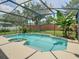 Sparkling swimming pool and spa within a screened enclosure, offering a private retreat at 3213 Kentshire Blvd, Ocoee, FL 34761
