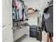 Walk-in closet with clothes on hangers and a rolling suitcase at 3213 Kentshire Blvd, Ocoee, FL 34761