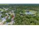 An aerial view of the neighborhood with a lake and mature trees at 322 Shadow Oak Dr, Casselberry, FL 32707