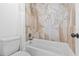 Bathroom featuring tile surround tub and shower with decorative tile accents and chrome fixtures at 322 Shadow Oak Dr, Casselberry, FL 32707