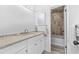 Bathroom featuring stone countertops, white vanity with chrome hardware, and a tub with tile surround at 322 Shadow Oak Dr, Casselberry, FL 32707