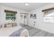 Bedroom with gray wood-look floors, neutral decor, and ample natural light from two windows with woven blinds at 322 Shadow Oak Dr, Casselberry, FL 32707