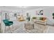 Bright living room with wood-look floors, modern decor, and seamless flow into kitchen and dining areas at 322 Shadow Oak Dr, Casselberry, FL 32707