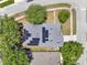 Aerial view of a house with solar panels on the roof, surrounded by mature trees at 3259 Alling Ct, Deltona, FL 32725