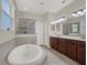 Relaxing bathroom featuring a soaking tub, walk-in shower, and dual vanities at 3259 Alling Ct, Deltona, FL 32725