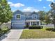 Charming two-story home with a well-manicured lawn and two car garage at 3259 Alling Ct, Deltona, FL 32725