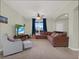 A spacious living room featuring neutral walls, carpet and a large sectional sofa at 3259 Alling Ct, Deltona, FL 32725