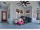 Covered patio with a ceiling fan and ample space for outdoor furniture and play equipment at 3259 Alling Ct, Deltona, FL 32725
