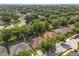 This aerial shot shows a home with a screened pool and solar panels in a neighborhood lush with mature trees at 356 Via Tuscany Loop, Lake Mary, FL 32746