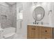 Bright bathroom featuring modern vanity, round mirror, tub with tiled walls, and white marble flooring at 356 Via Tuscany Loop, Lake Mary, FL 32746