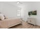 Cozy bedroom featuring natural light, ceiling fan, TV, and a light colored wooden floor at 356 Via Tuscany Loop, Lake Mary, FL 32746
