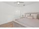 Bright bedroom featuring a ceiling fan, view into hall, and a light colored wooden floor at 356 Via Tuscany Loop, Lake Mary, FL 32746
