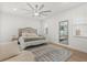 Serene bedroom with a ceiling fan, large mirror, and a comfortable chair, creating a peaceful retreat at 356 Via Tuscany Loop, Lake Mary, FL 32746